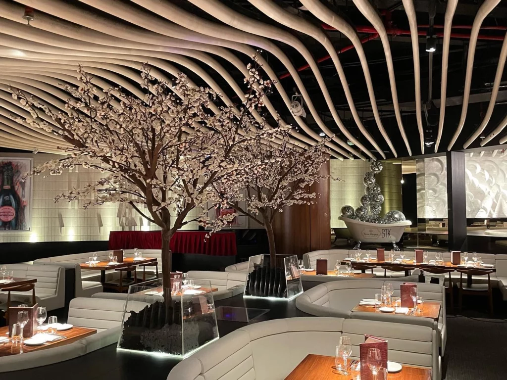 Indoor artificial cherry blossom tree installation at STK Restaurant in Dubai, supplied by artificial plant suppliers UAE