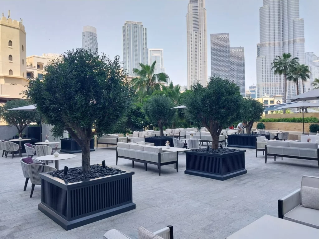 Luxurious dining area adorned with artificial sunproof plants in Saudi Arabia
